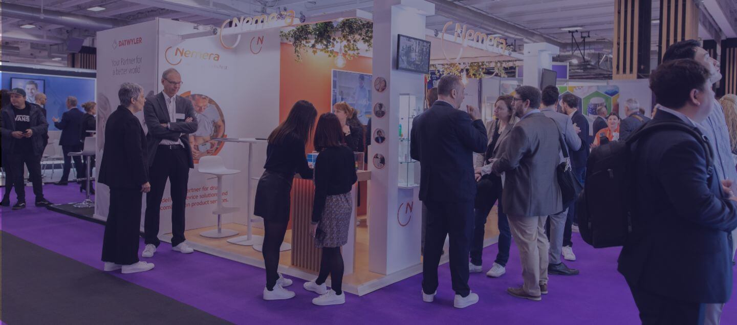 People standing at a product exhibition stand at a Pharmapack event