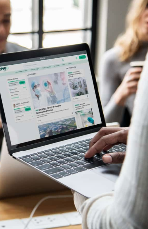 Man using laptop to view cphi online website